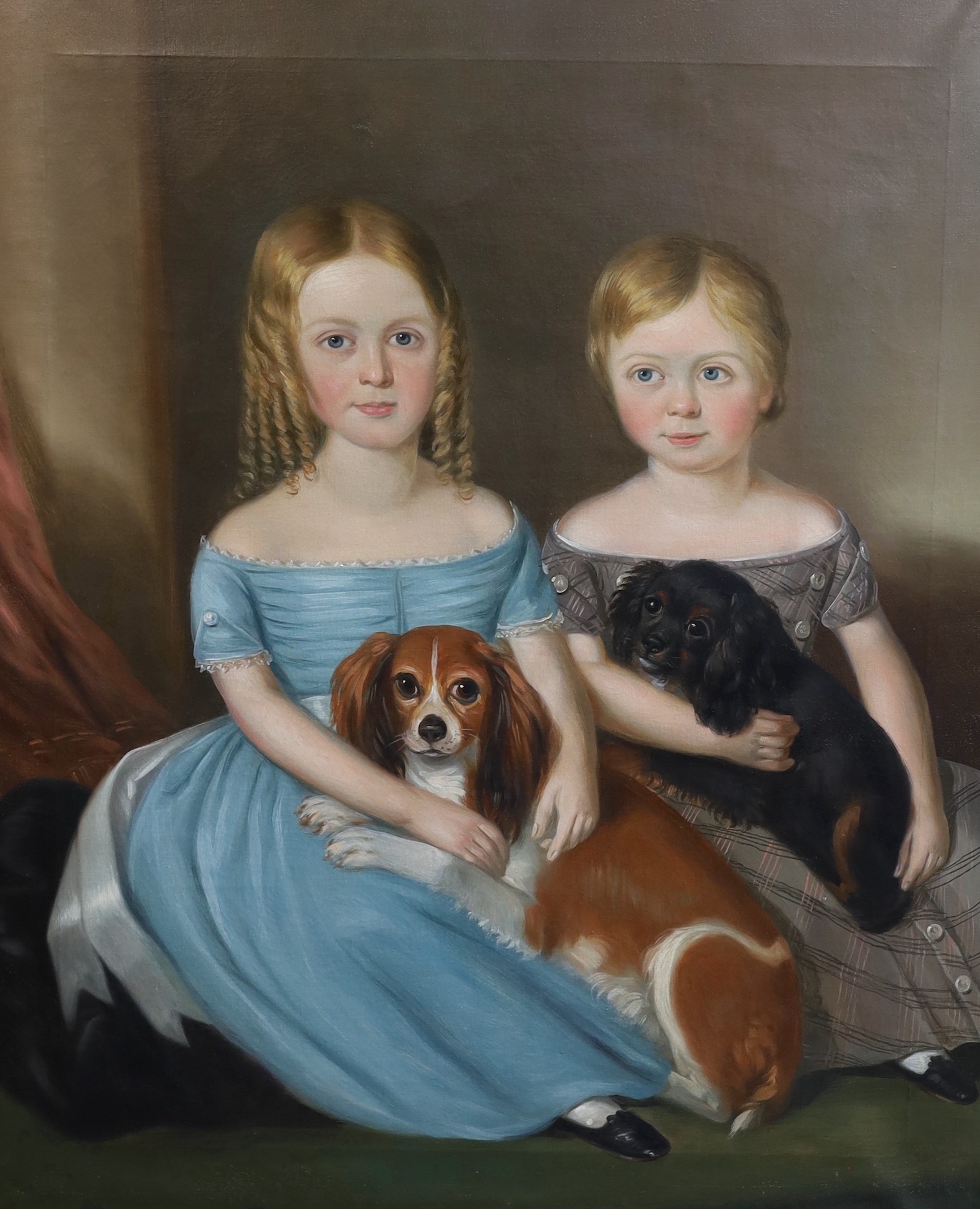 Mid 19th century English School, Portrait of two children seated with their King Charles Spaniels, oil on canvas, 91 x 74cm